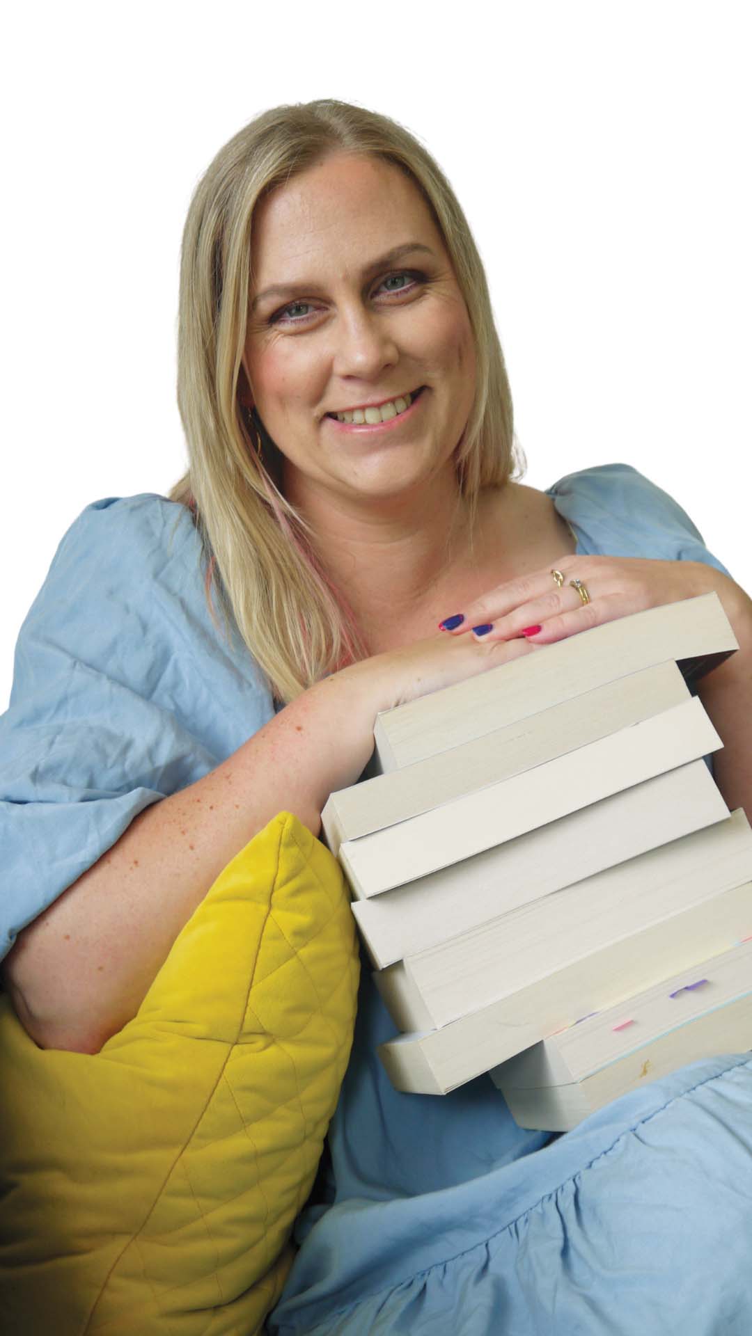 Lynda Tomalin Author portrait with stack of books