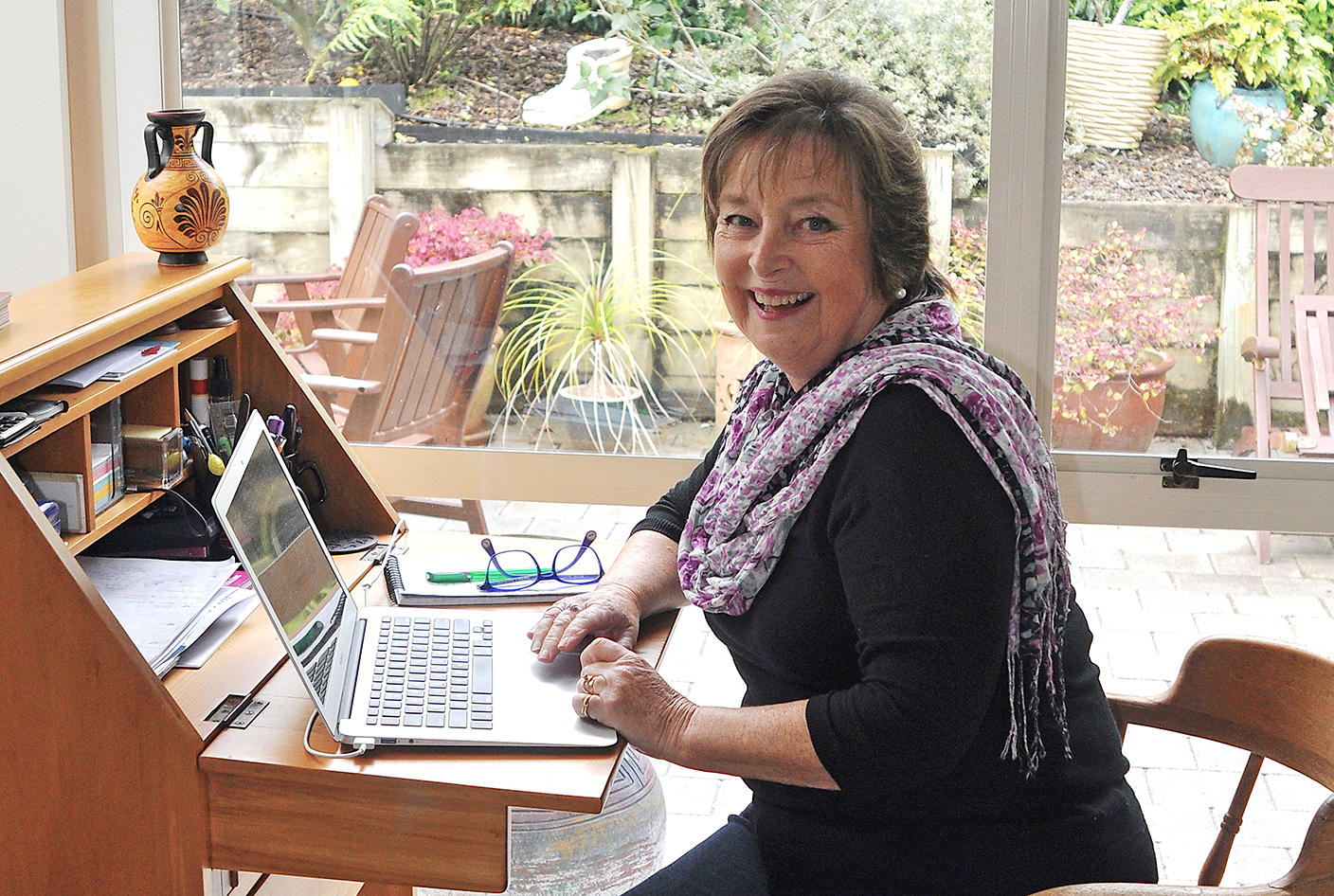Author Vicky Adin sitting at her writing desk