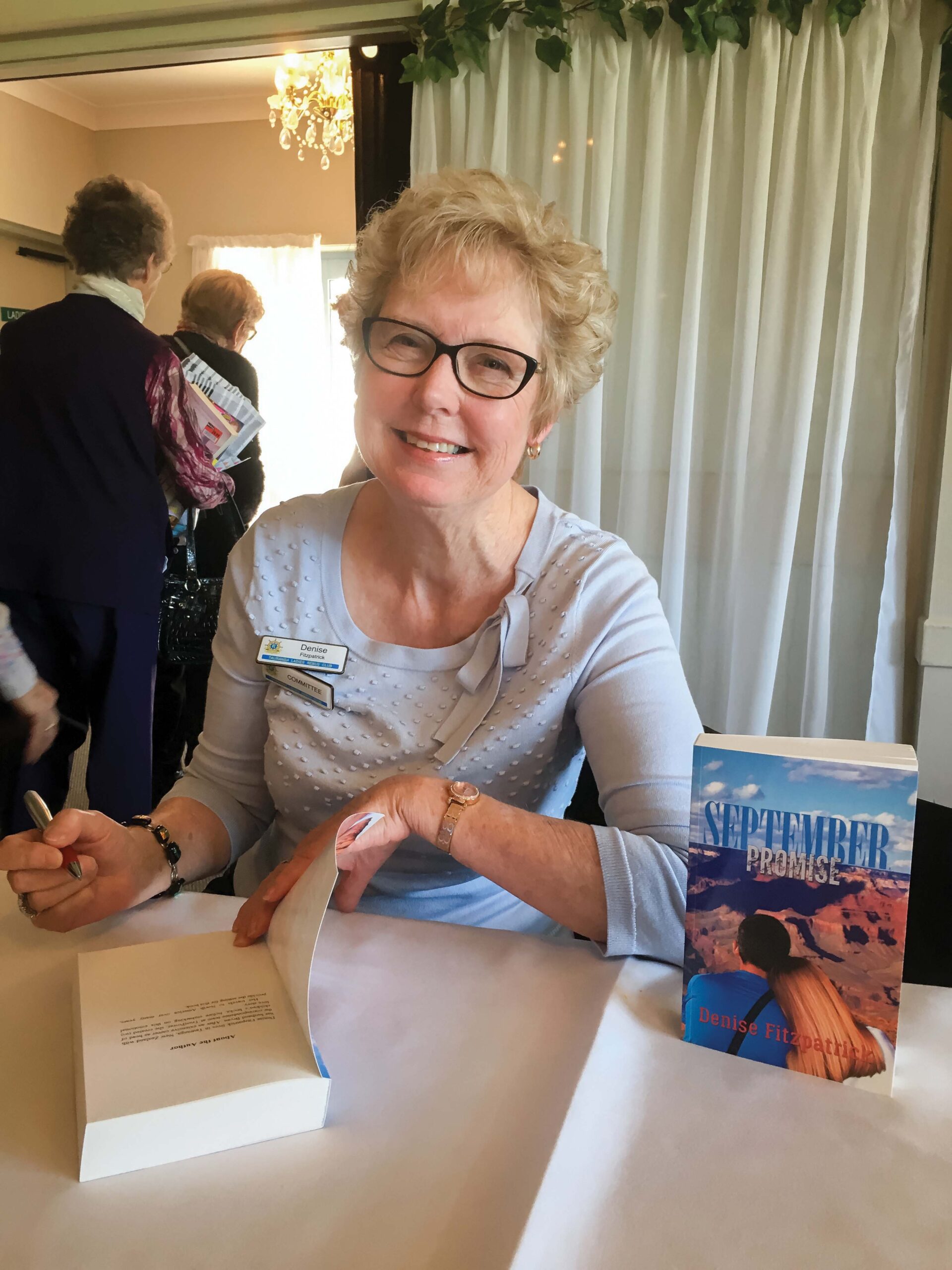 Independent author Denise Fitzpatrick signs her book "September Promise"